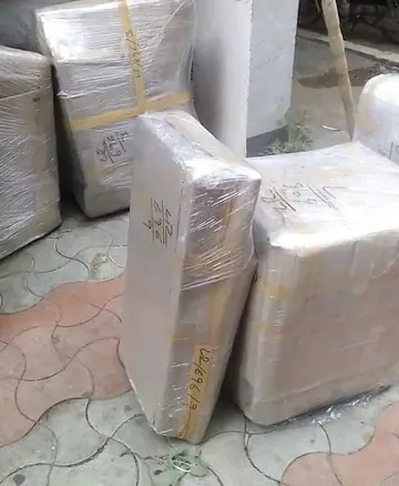 Cartons and furniture wrapped in clear stretch film