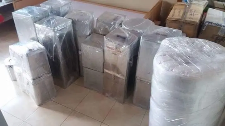 Stretch-wrapped furniture and cartons grouped together